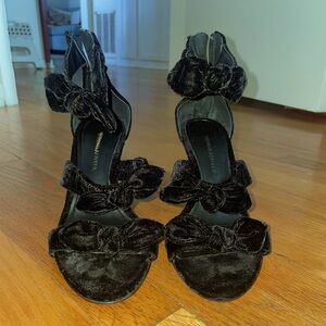 Black velvet pumps with bow detailing.